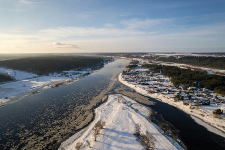 An illustrative photo of a river running through a snow covered countryside