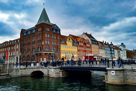 Photo by Unsplash An illustrative photo of a group of people walking across a bridge over a river