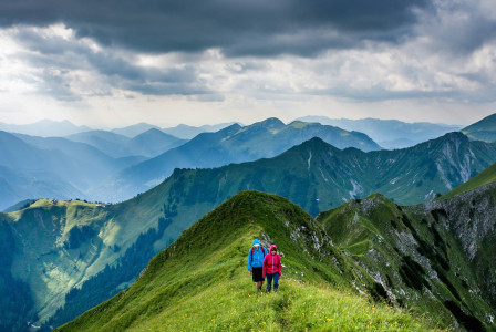 An illustrative photo of people walking on top of mountain