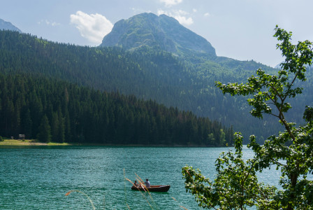 Photo by Unsplash An illustrative photo of a boat floating on a lake with mountains in the background