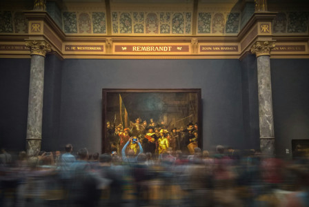 An illustrative photo of people looking at a painting in a museum