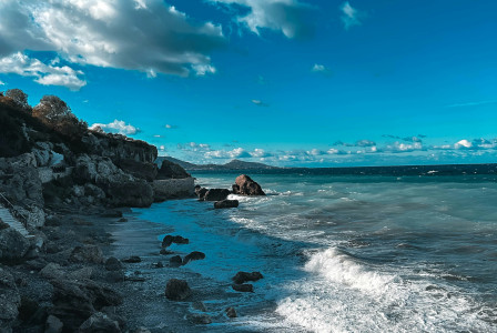 An illustrative photo of a view of the ocean from a rocky shore