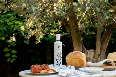 An illustrative photo of a table with food and a bottle of olive oil