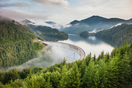 An illustrative photo of white bridge between mountains.