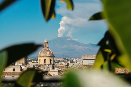 An illustrative photo of a view of a city with a mountain.