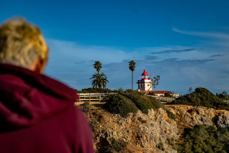 An illustrative photo of a person standing near a house.