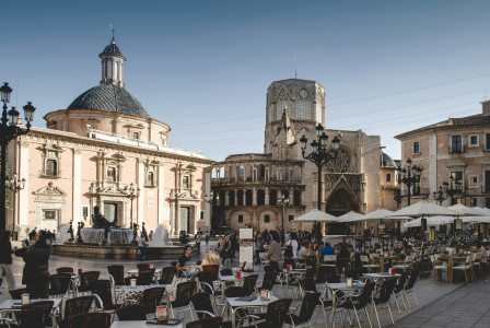 Photo by Unsplash An illustrative photo of tables and chairs near building.