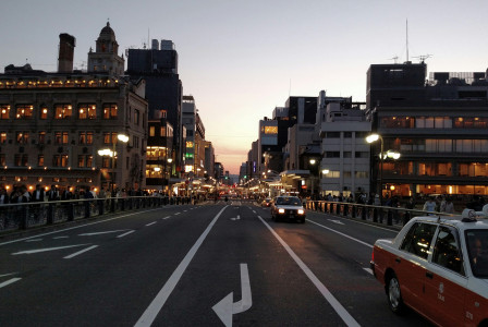 An illustrative photo of vehicles between commercial buildings.