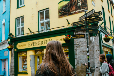 An illustrative photo of a woman walking down a street in Ireland