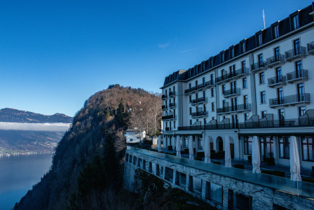 An illustrative photo of a building on a cliff overlooking a body of water