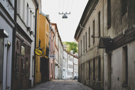 An illustrative photo of a narrow street between old buildings