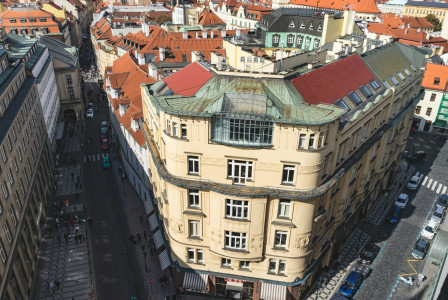 An illustrative photo of a building in Prague between two roads