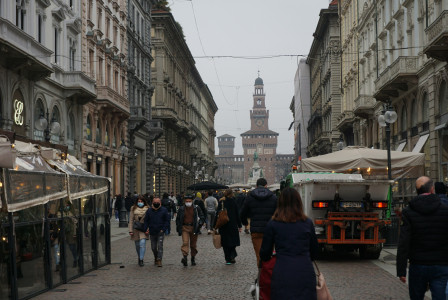 An illustrative photo of people walking on a street during cloudy weather