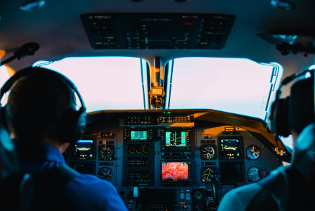 An illustrative photo of two pilots sitting in the airplane