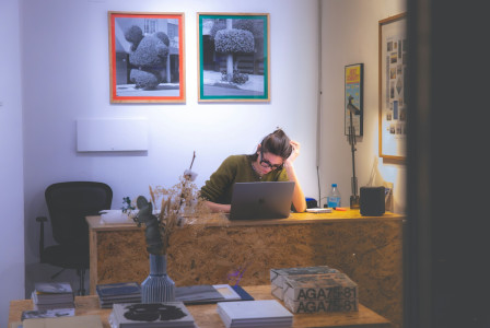Photo by Unsplash An illustrative photo of a man sitting at a desk.