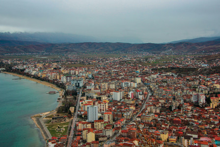 An illustrative photo of city buildings on a coast near a body of water