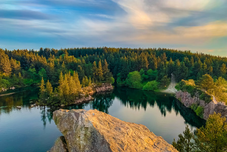 An illustrative photo of a lake in the middle of forest