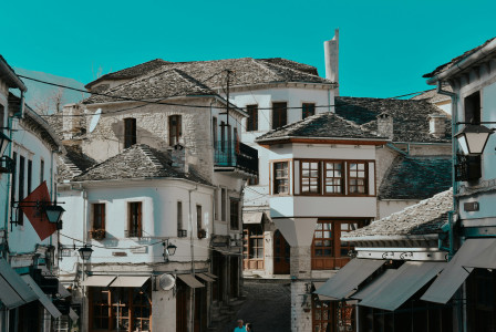 An illustrative photo of white and brown houses under blue sky