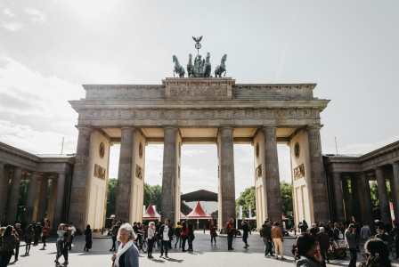 An illustrative photo of people walking near Brandenburg Gate