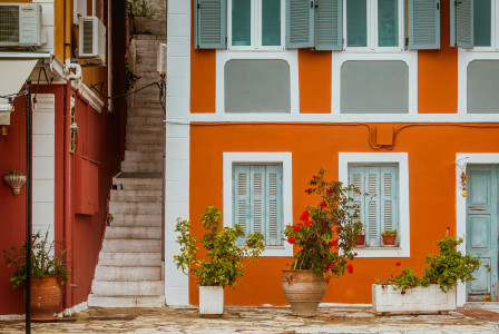 An illustrative photo of an orange concrete building in Greece