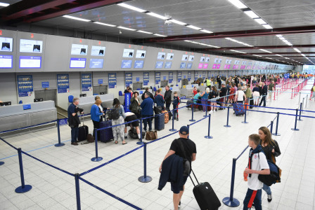 An illustrative photo of people standing in a queue in the airport