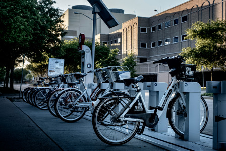 Image by Unsplash An illustrative photo of electric bicycles parked on the sidewalk.