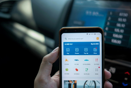 An illustrative photo of a person holding a smartphone.