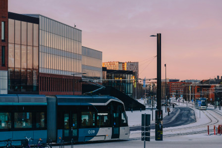 An illustrative photo of a tram driving down a snow covered street.