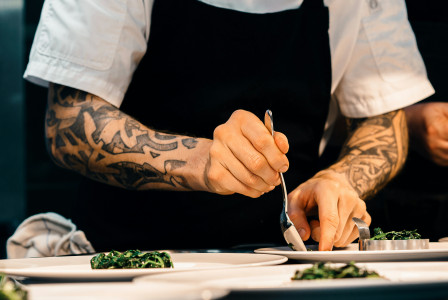 Image by Unsplash An illustrative photo of a person putting food on a plate.