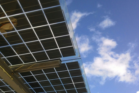 An illustrative photo of a solar energy panel with blue sky in the background.