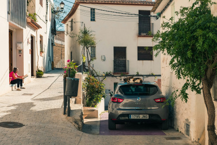 Photo by Unsplash An illustrative photo of a car parked near a building.