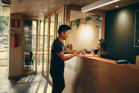 An illustrative photo of a man standing beside counter.