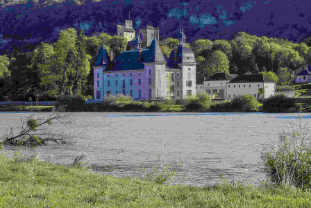 An illustrative photo of a large castle sitting on top of a lush green hillside.