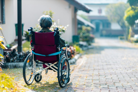 An illustrative photo of a woman sitting on wheelchair.