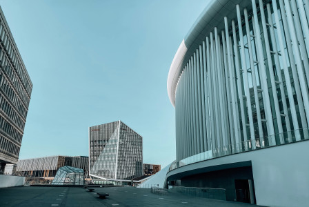An illustrative photo of white and a gray concrete building during daytime.