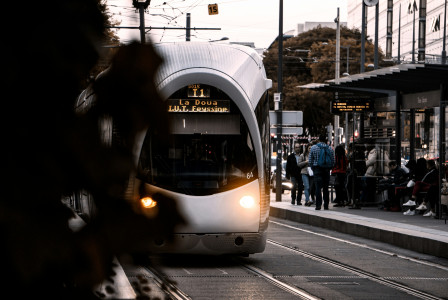 An illustrative photo of a white subway train during daytime.