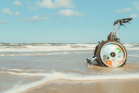 An illustrative photo of a wheelchair and the sea.