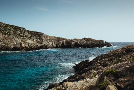 An illustrative photo of a formation of rocks in a sea.