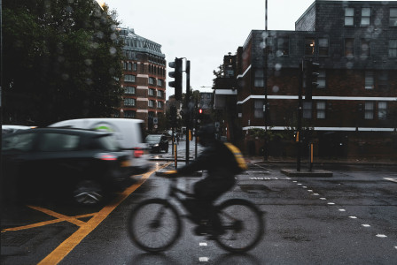 Photo by Unsplash An illustrative photo of a person riding a bike on a city street.