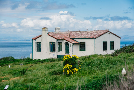 Photo by Unsplash An illustrative photo of a house on a grassy hillside.
