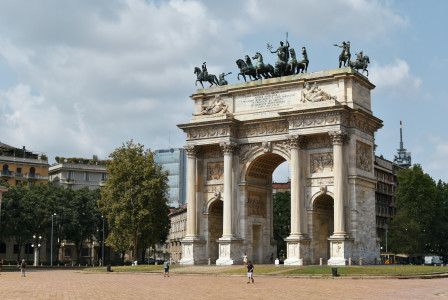 An illustrative photo of a stone arch with statues on top of it.