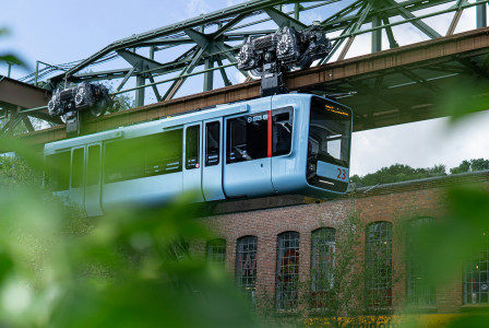 An illustrative photo of a blue train flowing in the air.