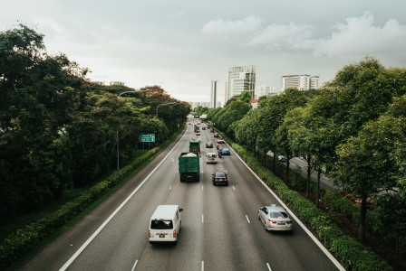 An illustrative photo of cars on a road during daytime.