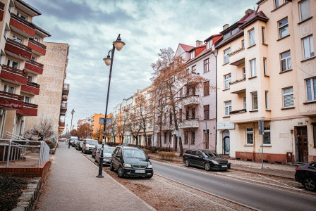 An illustrative photo of a person sitting on a bench in front of a building