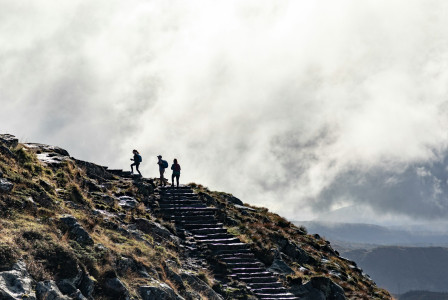 An illustrative photo of a person standing on rocky mountain.