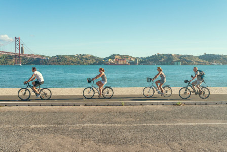An illustrative photo of people riding bicycles on the road.