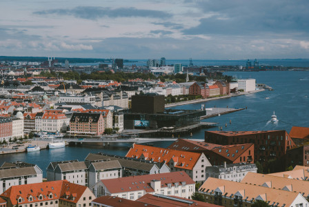 An illustrative photo of city buildings near a body of water.