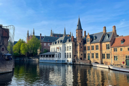 An illustrative photo of a river running through a city next to tall buildings.
