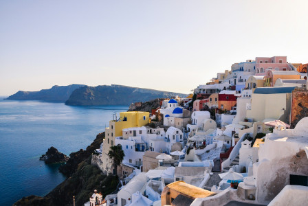 Photo by Unsplash An illustrative photo of houses on a hill near a sea.
