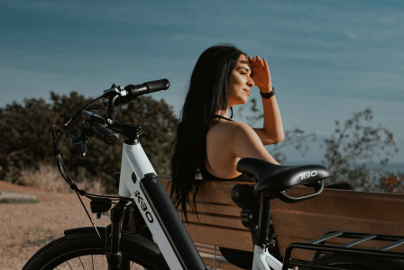 Photo by Unsplash An illustrative photo of a woman sitting next to a bicycle.